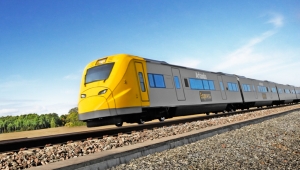 Arlanda Express train on the rail, bright yellow towards a blue sky. Photo.