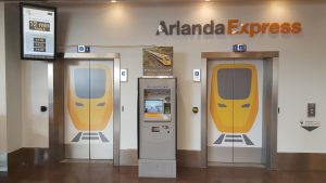 Ticketbox near doors under Arlanda Express sign. Photo. 