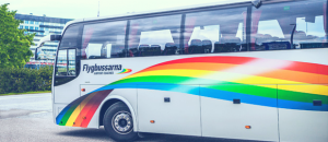 Gray bus with rainbow decal. Photo. 